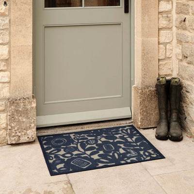Kukkia Dark Navy Outdoor Doormat. Made from ECONYL regenerated yarn featuring a floral pattern.