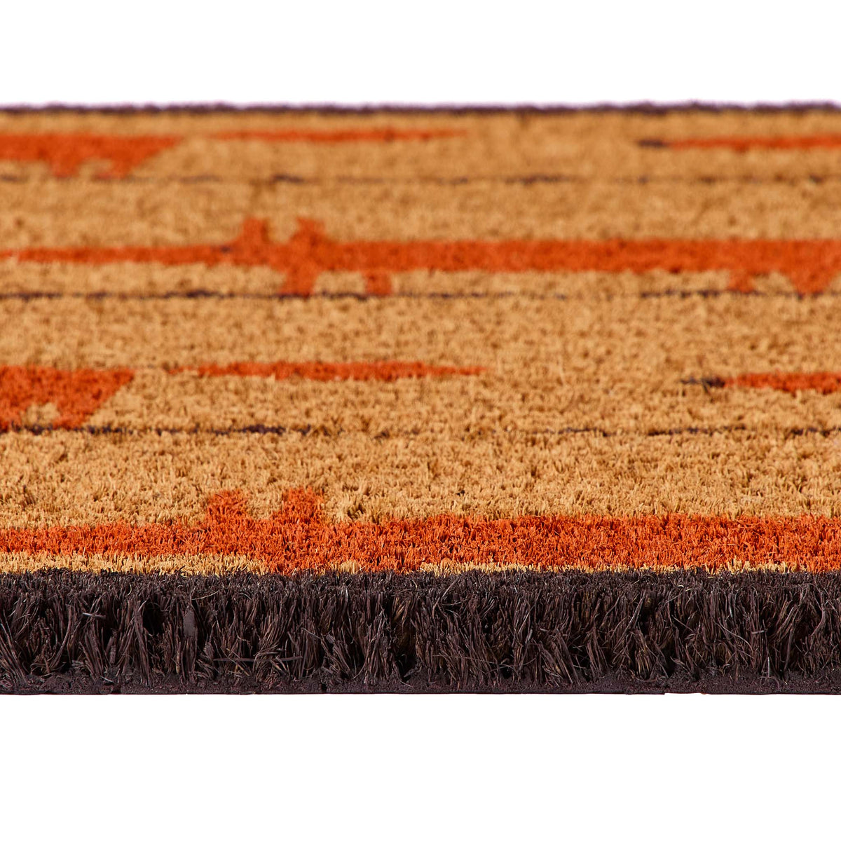 Close-up of a textured doormat with a natural coir background, rust-orange fox pattern, and dark brown fringe along the bottom edge.