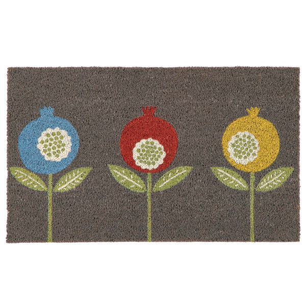 A rectangular grey coir doormat featuring a stylized pattern of three pomegranate-like flowers in blue, red, and yellow with green leaves and stems on a white background.