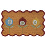 A rectangular coir doormat with a scalloped dark red border and three stylized flower motifs in blue, brown, and yellow on a natural background.