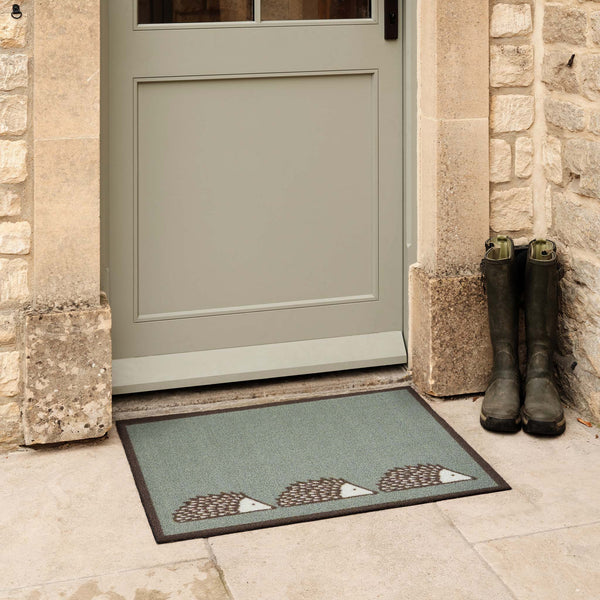 Spike Green Outdoor Doormat. Made from ECONYL regenerated yarn featuirng three hedgehogs.