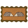 A rectangular coir doormat with a scalloped dark green border and a central design of two facing hedgehogs on a natural background, isolated on a white backdrop.