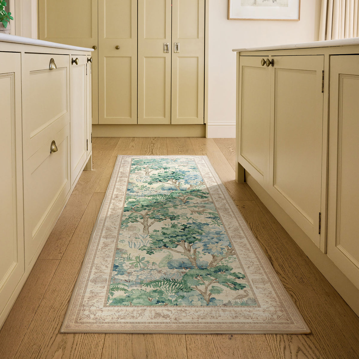 Sanderson By Highgrove x Hug Rug Eco-Washable The Stumpery Fern Runner with a nature inspired pattern, styled on wooden flooring.