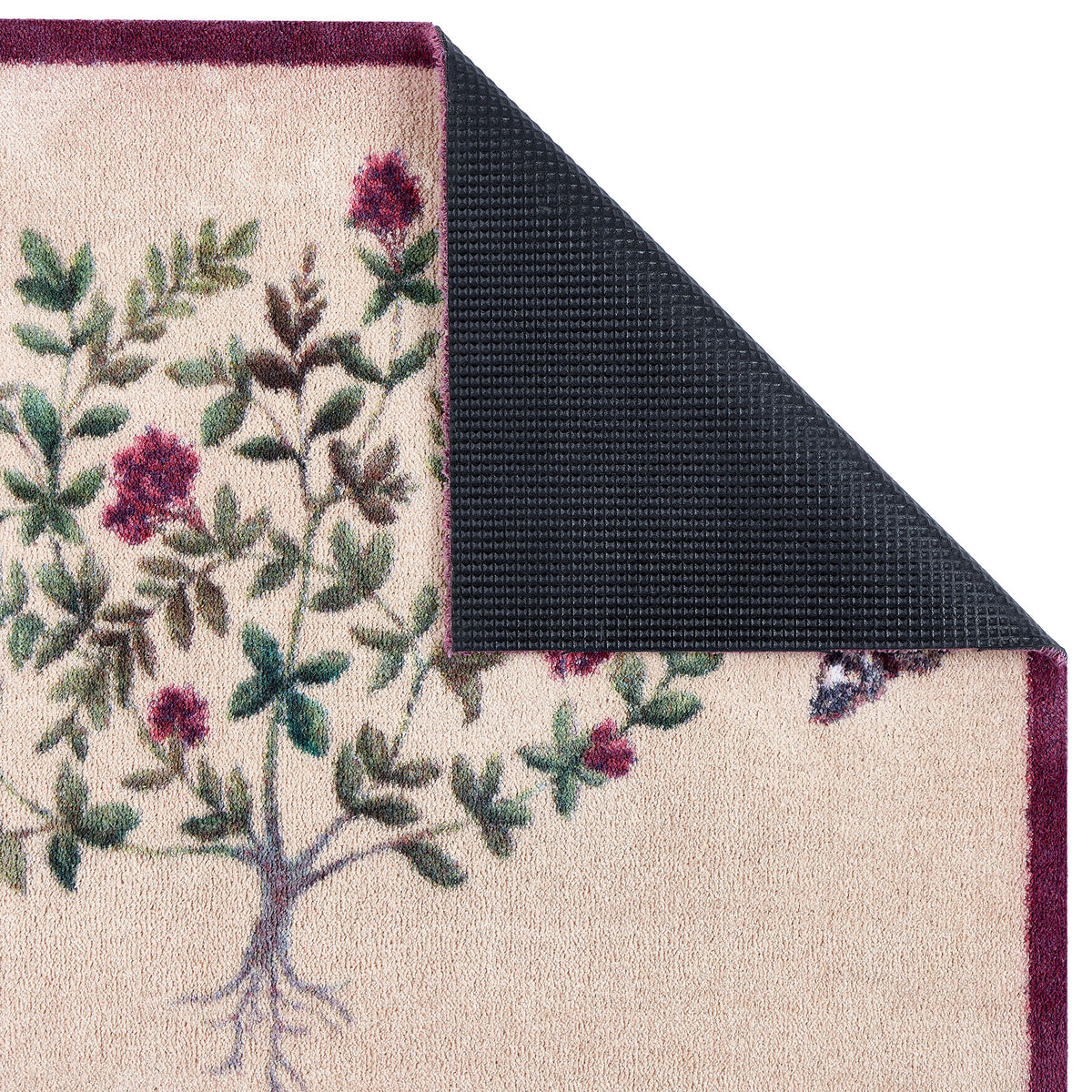 Close-up of Sanderson By Highgrove x Hug Rug Thyme Walk Damson & Quince Doormat showing the rubber backing. 