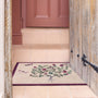 Sanderson By Highgrove x Hug Rug Thyme Walk Damson & Quince with a floral design, styled on tile flooring.
