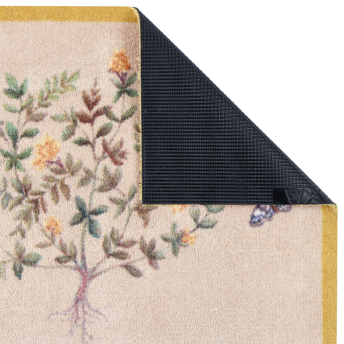 Sanderson By Highgrove x Hug Rug Thyme Walk Lichen & Gooseberry with a floral design showing the rubber backing.