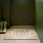 Sanderson By Highgrove x Hug Rug Thyme Walk Lichen & Gooseberry with a floral yellow design, styled by a green door. 