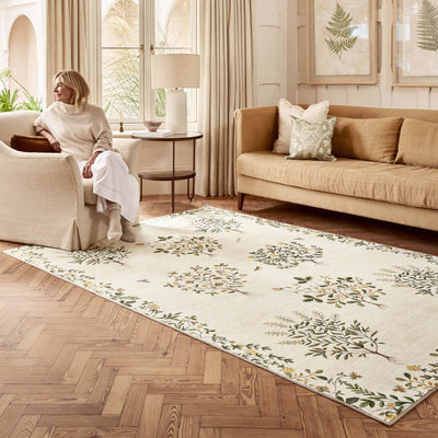 Sanderson By Highgrove x Hug Rug Eco-Washable Thyme Walk Lichen & Gooseberry with a nature inspired pattern, styled in a living room. 