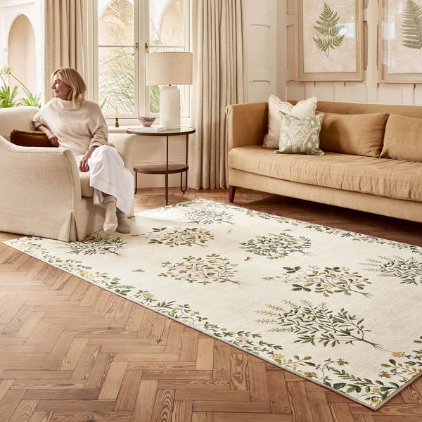 Sanderson By Highgrove x Hug Rug Eco-Washable Thyme Walk Lichen & Gooseberry with a nature inspired pattern, styled in a living room. 
