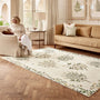 Sanderson By Highgrove x Hug Rug Eco-Washable Thyme Walk Lichen & Gooseberry with a nature inspired pattern, styled in a living room. 