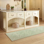Sanderson By Highgrove x Hug Rug Eco-Washable Topiary View Thyme Runner in green with a traditional style pattern, styled on wooden flooring.