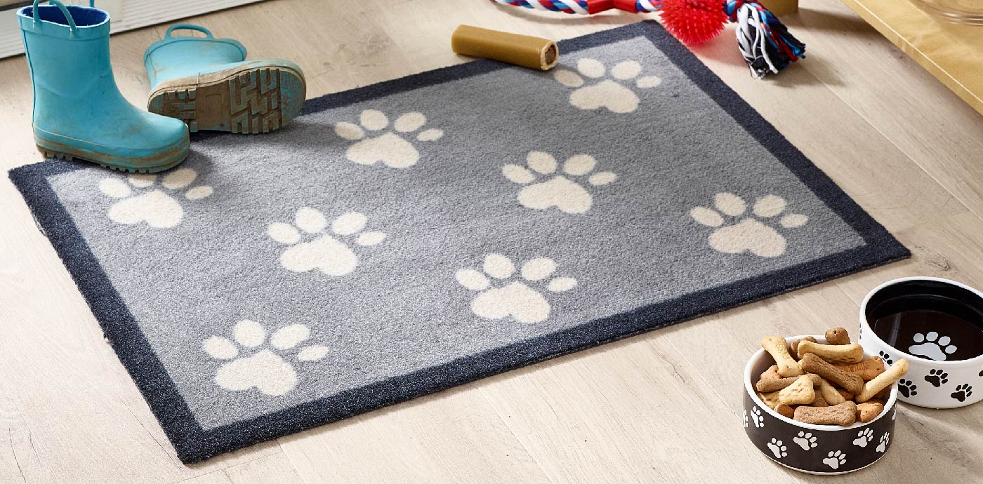 Washable doormat with paw print design at back door