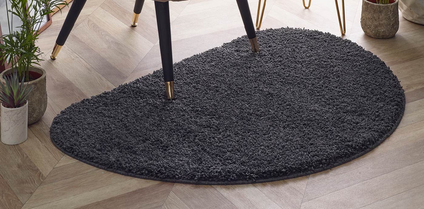 Black half moon shaggy rug under dining room chair