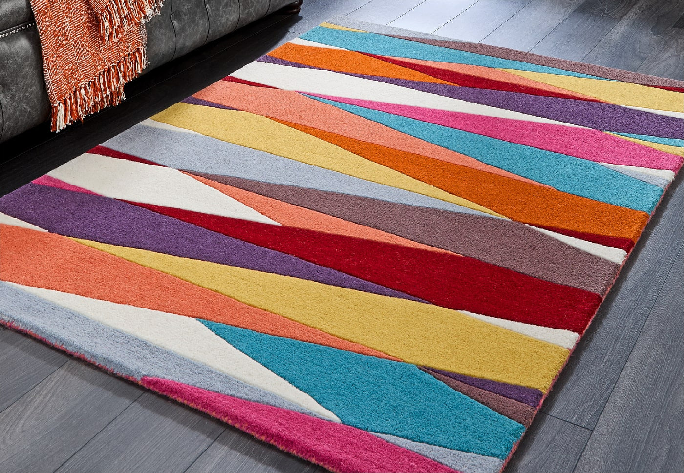 a multicolour shards wool rug from phoenox textiles on a living room floor