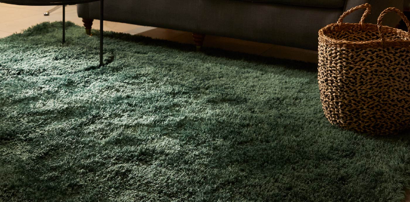 Shaggy green area rug on living room floor, manufactured by Phoenox Textiles