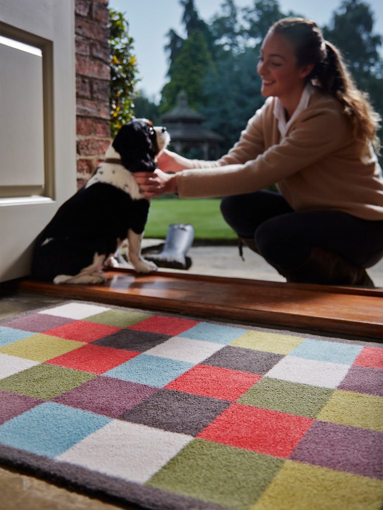dog getting petted by owner on a Hug Rug